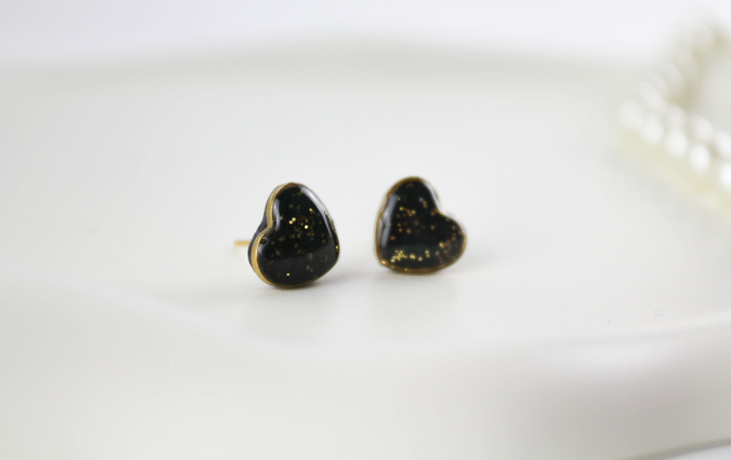 Small Black and Gold Resin Stud Earrings in Gold-Colored Heart Setting