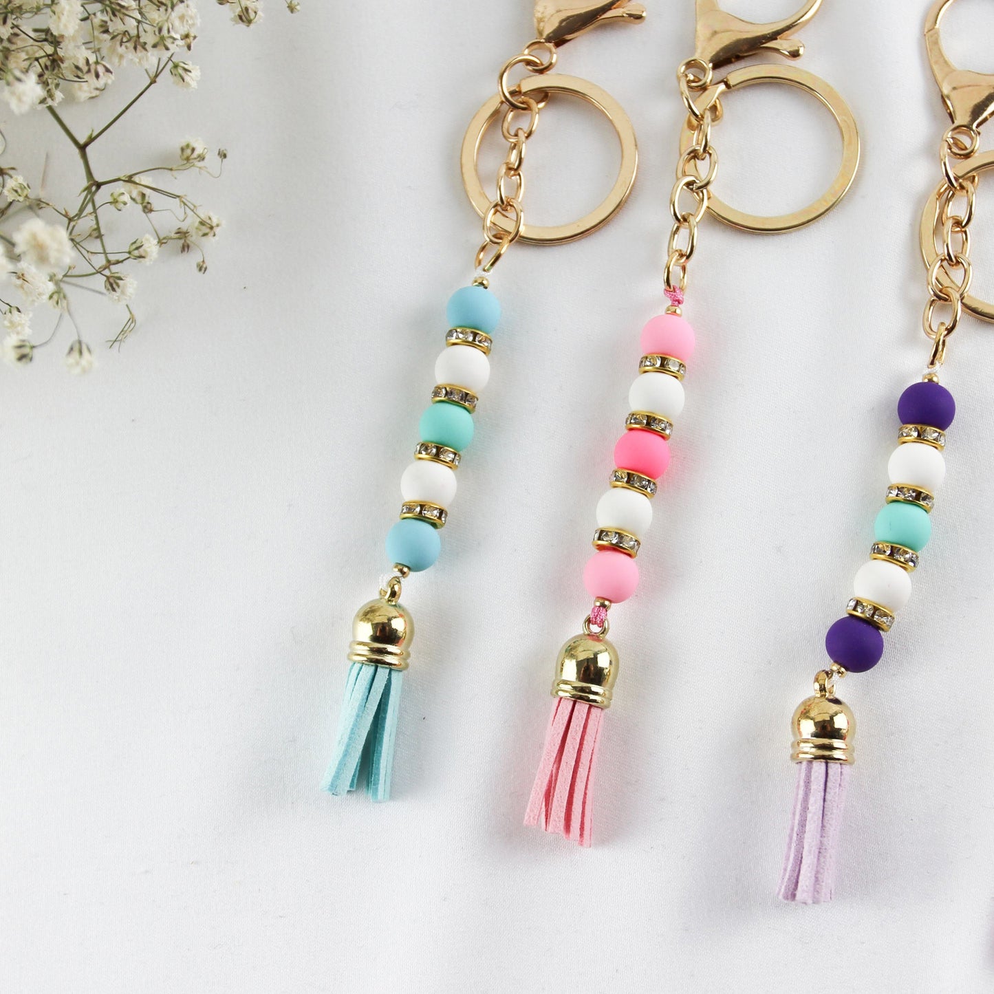 Pearl Tassel Pop –  Farbfroher Perlen-Schlüsselanhänger mit Strass & Quaste