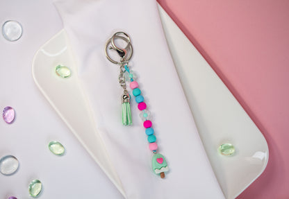 Happy Creamy Schlüsselanhänger - Perlen, Charm & Quaste